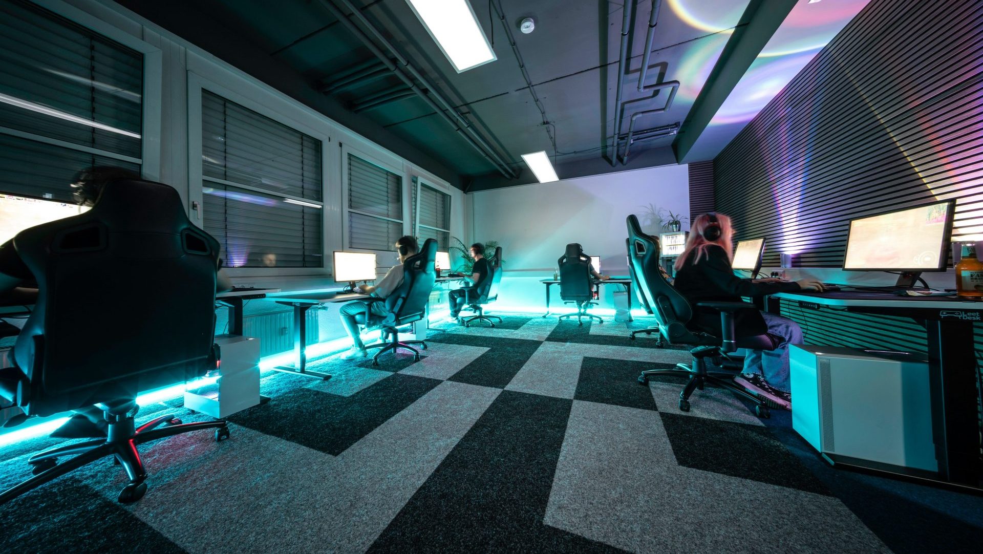A group of people sitting in a room with computers